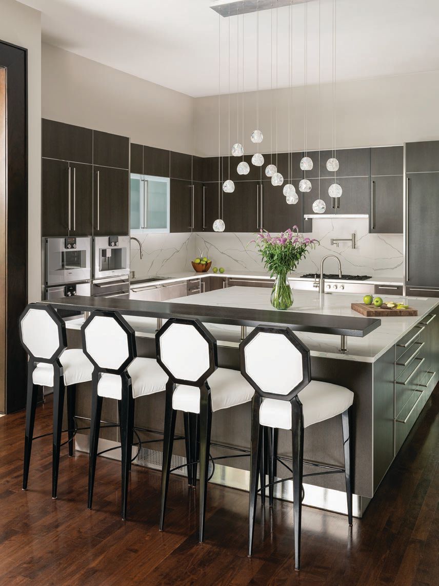 The modern kitchen features all brand-new Gaggenau appliances and custom lighting PHOTO COURTESY OF IBB DESIGNS