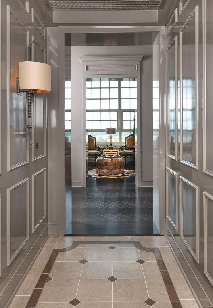 Polished marble and herringbone wood floors are a few key design elements that set this space apart PHOTO COURTESY OF PIASSICK PHOTO