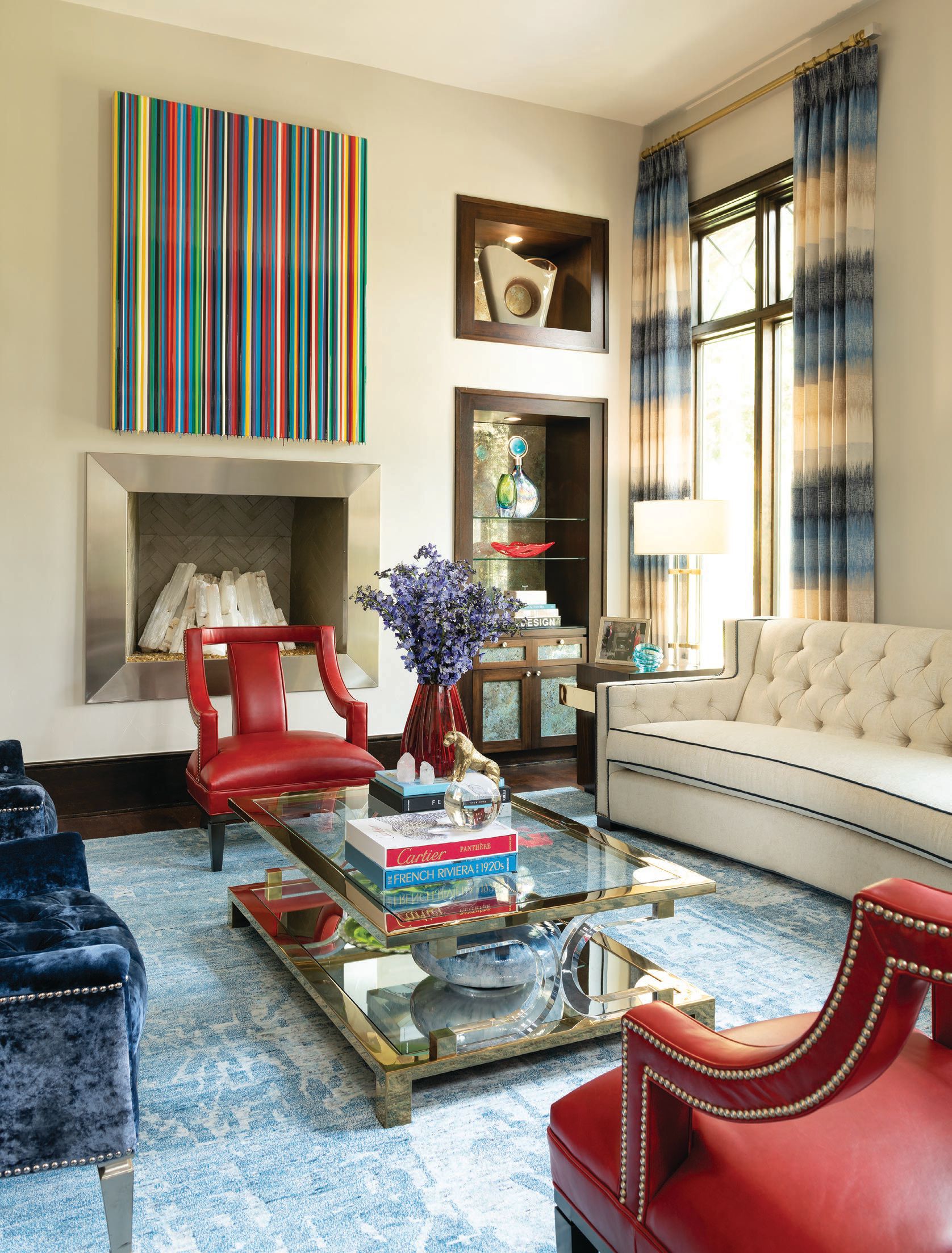 Colorful art from Laura Rathe Fine Art alongside custom accessories by IBB Design complete the formal living room. PHOTO COURTESY OF IBB DESIGNS