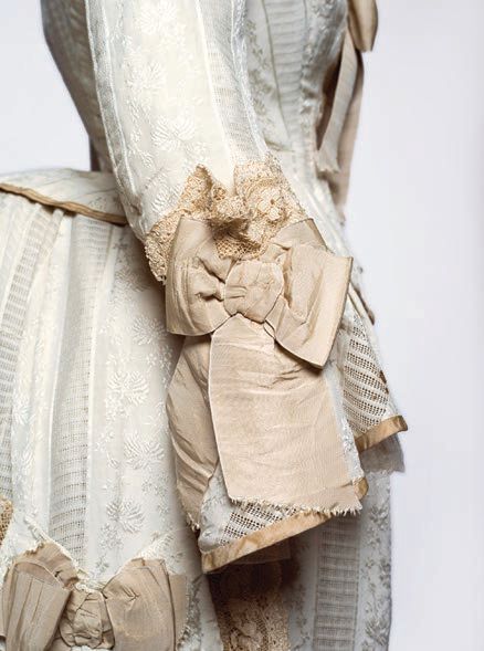 Bodice, skirt and overskirt detail (1875-1880, silk, linen, cotton, metal and bone) BODICE, SKIRT AND OVERSKIRT (DETAIL) AND TRAJE A “LA FRANCESA” DETAIL, MUSEO DEL TRAJE, MADRID, PHOTO BY JESÚS MADRIÑÁN